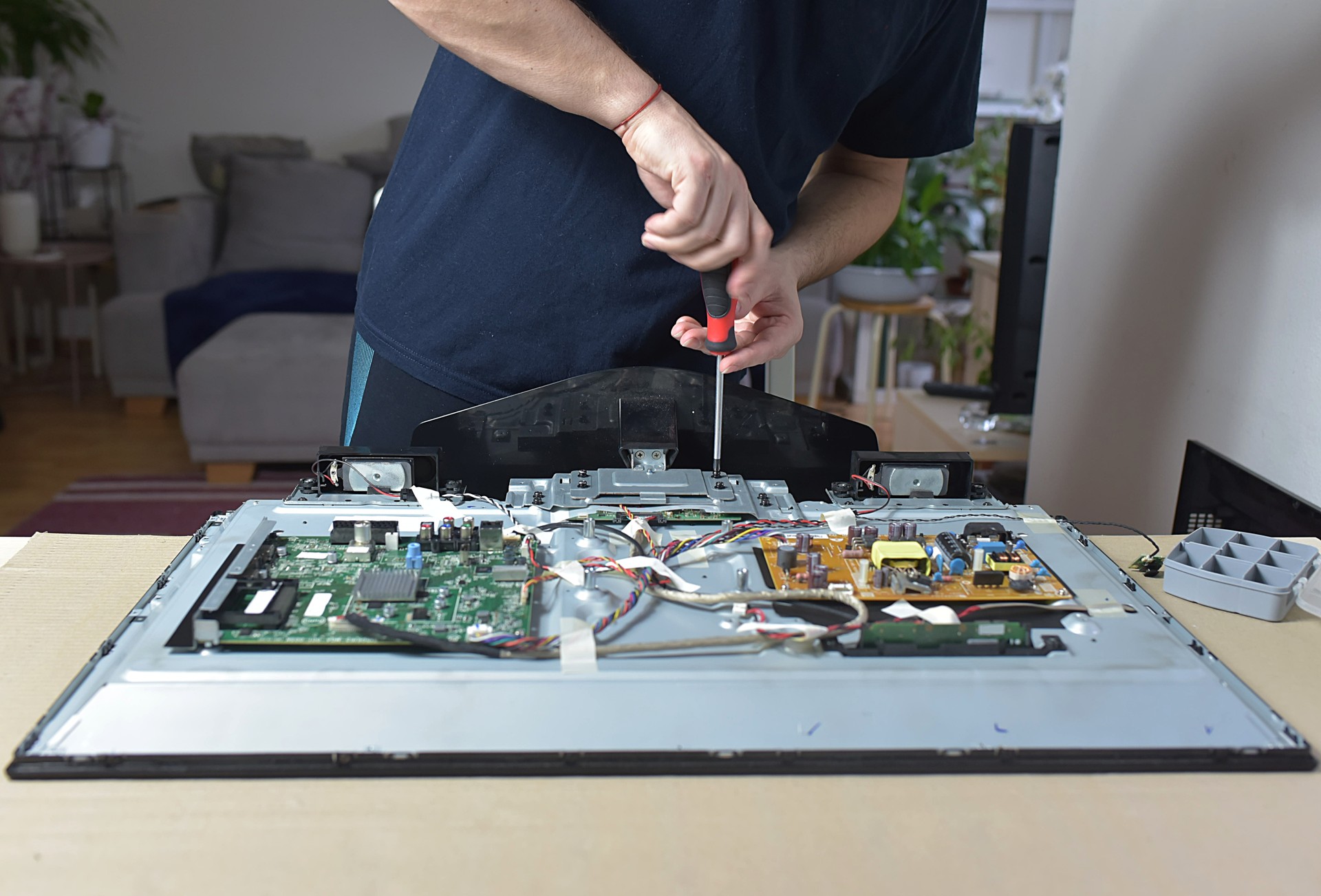 The man repairing broken tv at home